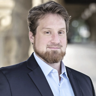 Portrait of Johannes in a suit smiling softly